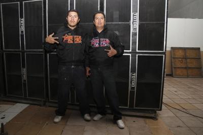 Two guys in their tropical sound system fan jackets, dance with Sonido Super Dengue and Polymarchs at Olímpico, Pantitlán neigborhood, Mexico City, 2014 (photo: Mirjam Wirz)