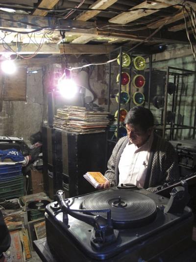 Sonido Coronado/Señor Cruz with DJ equipment and record collection in the house of his family, Penon de los Banos neighborhood, Mexico City, 2010 (photo: Mirjam Wirz)