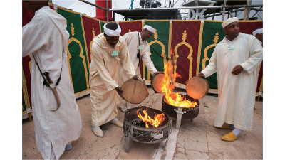 Ahwash musicians warming their bendirs at Timitar Festival, Agadir, Morocco, 2013 (photo: Gilles Aubry). 