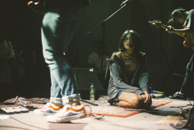 Singer of Singaporean band, Subsonic Eye, is captured sitting on the stage floor during a joint concert with Jakarta bands from Kolibri Rekords. Photo by Peter G. Y. Rumondor.